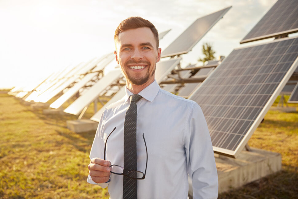 Cheerful investor on solar farm